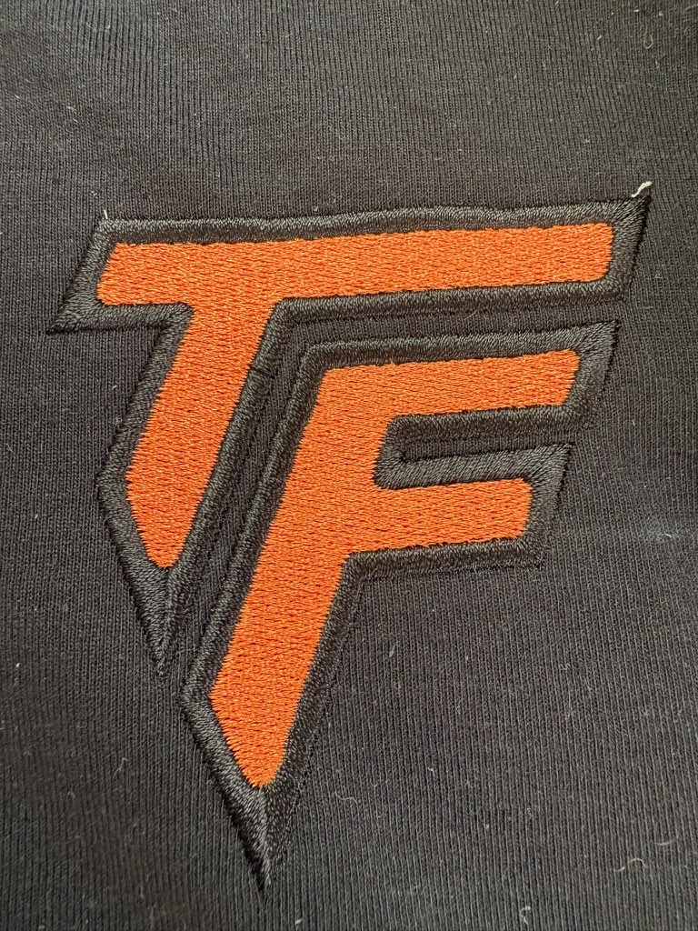 Close-up of the embroidered Terra Firma Built chest mark